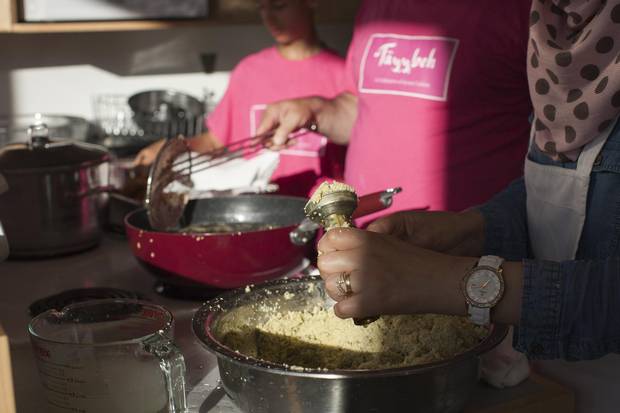 Leena Alahmad, right, prepares falafel pucks for the Shades of Green Festival dinner in Vancouver on May 26.