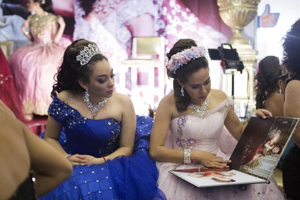 Models view a designer's lookbook at 15Fest.