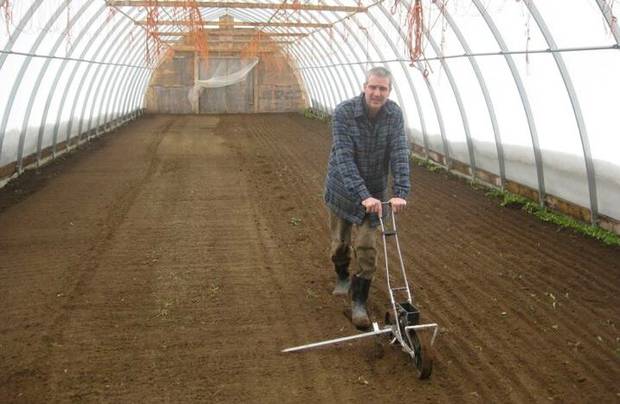 Brent Preston uses his old Jang to plant seeds in the greenhouse. 