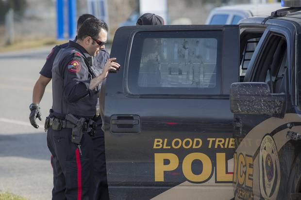 Constable Rayan Najjar with the Blood Tribe Police Service detains a local resident who was suspected of carrying a firearm.