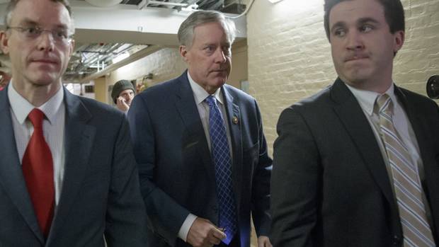 House Freedom Caucus Chairman Rep. Mark Meadows, R-N.C., center, rushes to a caucus in the basement of the Capitol in Washington, Friday, March 24, 2017, before House Speaker Paul Ryan of Wis. announced that he is abruptly pulling their troubled health care bill off the House floor.