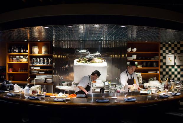 Chefs Masaaki Kudo, left, and Kazuki Nakamoto prepare sushi.