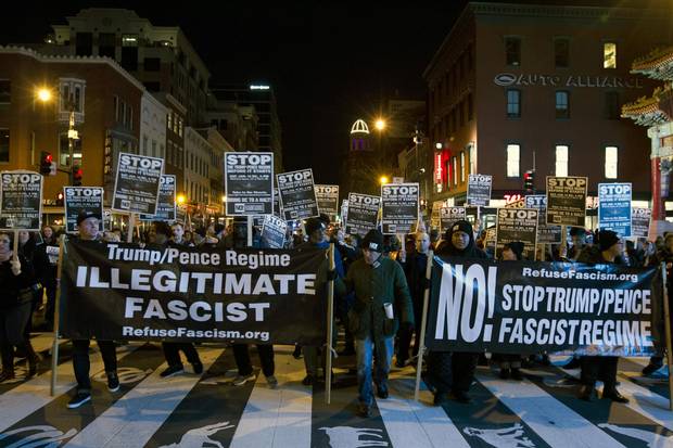 Demonstrators holds banners and signs during an anti-Trump march in downtown Washington on Jan. 15, 2017.