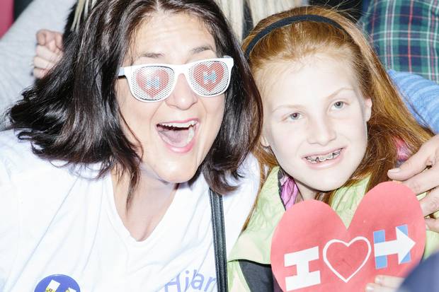 Jennifer McCann, of New York, and Savannah Mills-Hall, 10, of New Londond, N.H., pose for pictures in the crowd at Ms. Clinton’s rally at Southern New Hampshire University in Hooksett, N.H.