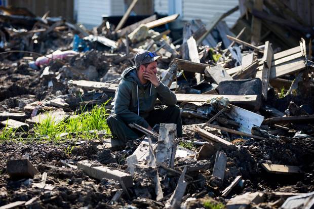 A resident looks over the damage in the Timberlea neighbourhood as thousands of evacuees who fled a massive wildfire begin to trickle back to their homes in Fort McMurray, Alta., on June 2, 2016.