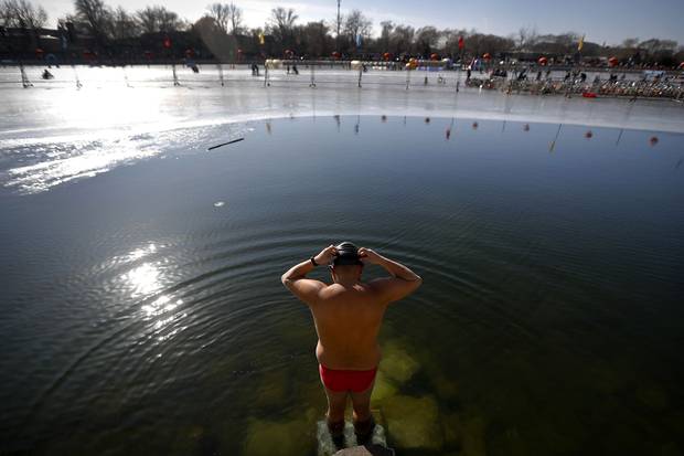 Jan. 24, 2018: A man prepares to swim in the half-frozen waters at the Shichahai Lake in Beijing. According to some of Beijing's local residents, swimming in the freezing water is good for their health.