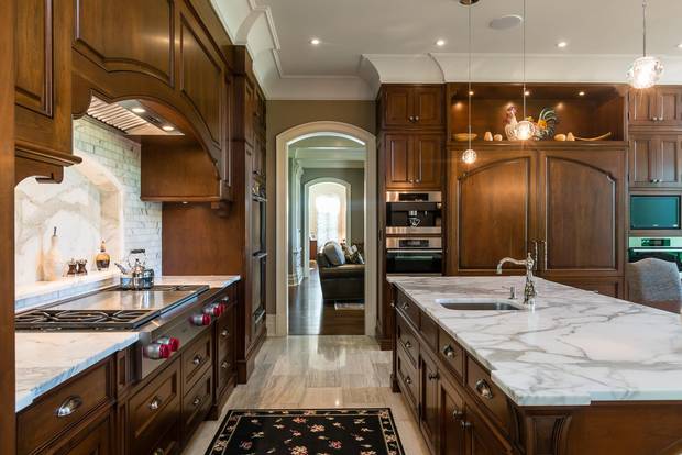 The kitchen features cherry cabinets, calacatta marble countertops and a Wolf French top stove.