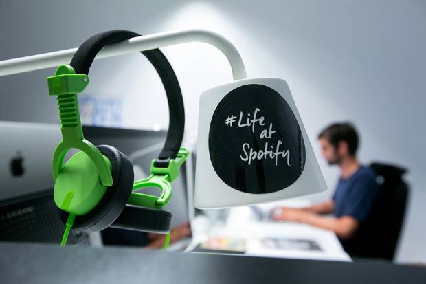 A pair of audio headphones hang from a lamp shade inside the offices music streaming company Spotify Ltd. in Berlin on Friday, June 17, 2016.