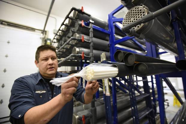 John Owl, an infrastructure technician with the Serpent River First Nation, displays the filters (membranes) used to treat water at a plant near Sudbury, Ont.