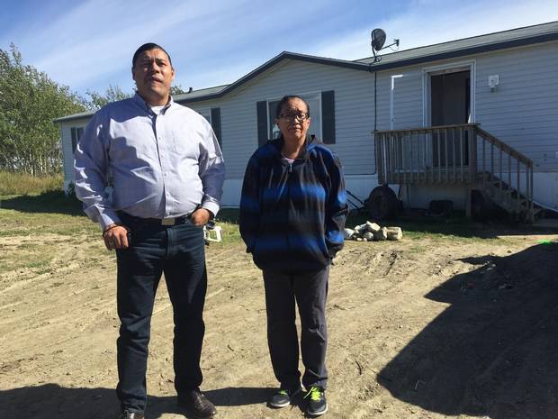 Colten’s mother, Debbie Baptiste, stands outside her home on the Red Pheasant First Nation with former chief Sheldon Wuttunee.