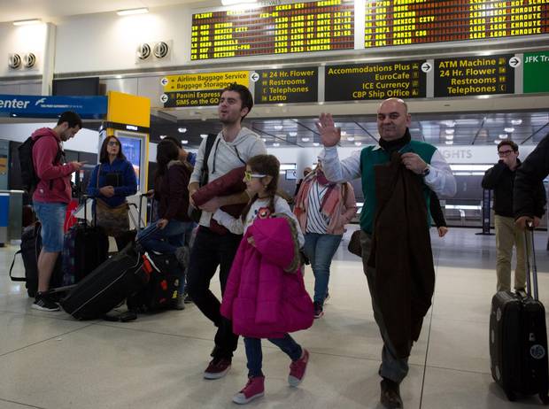 Fuad Sharef Suleman, right, and two of his children arrive in New York on Sunday. The Iraqi family was previously prevented from boarding a plane to the United States following U.S. President Donald Trump’s executive order to temporarily bar travellers from seven countries, including Iraq.
