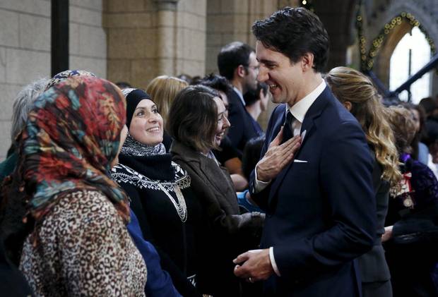 Mr. Trudeau greets guests in the Hall of Honour before the speech.