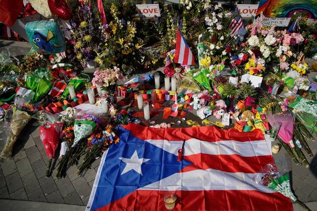 A Puerto Rican flag is left at a makeshift memorial near Orlando Regional Medical Center Wednesday, down the street from the Pulse Nightclub where the June 12 shooting took place.