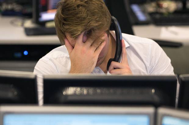 Traders from ETX Capital work in central London react after the U.S. election result on Nov. 9, 2016.