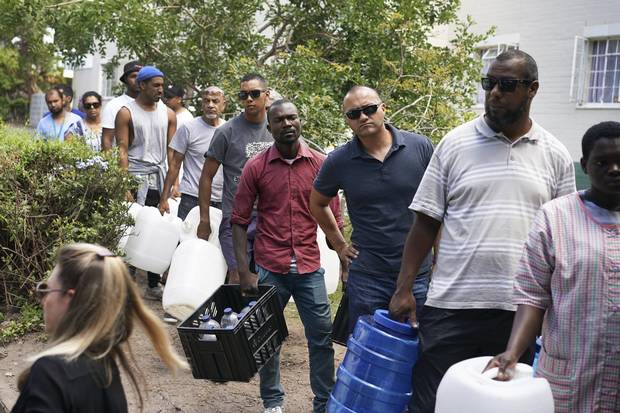 Residents collect water from a spring in the Newlands area of Cape Town on Jan. 22, 2018.