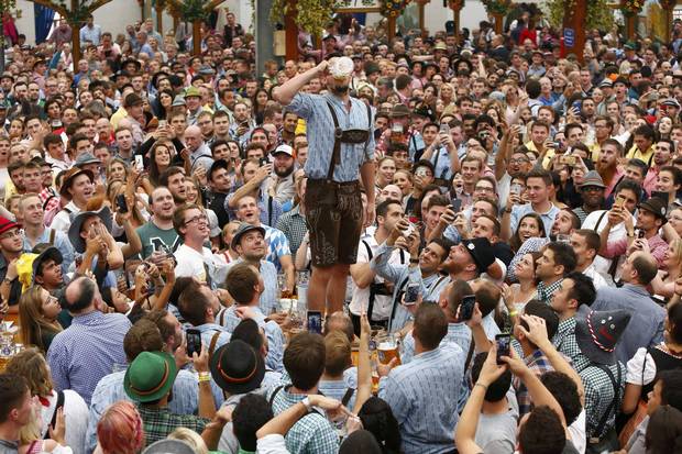 A visitor drinks beer during the opening day of the 183rd Oktoberfest in Munich, Germany, September 17, 2016.