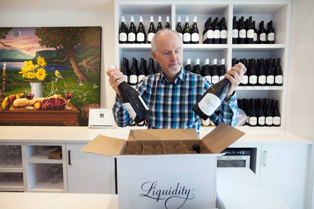Ian MacDonald, president of Liquidity Wines in Okanagan Falls, B.C., prepares to open the winery's tasting room on Feb. 9, 2018. Alberta's government has announced a ban on B.C. wine imports are part of an escalating fight over Kinder Morgan's Trans Mountain pipeline expansion.