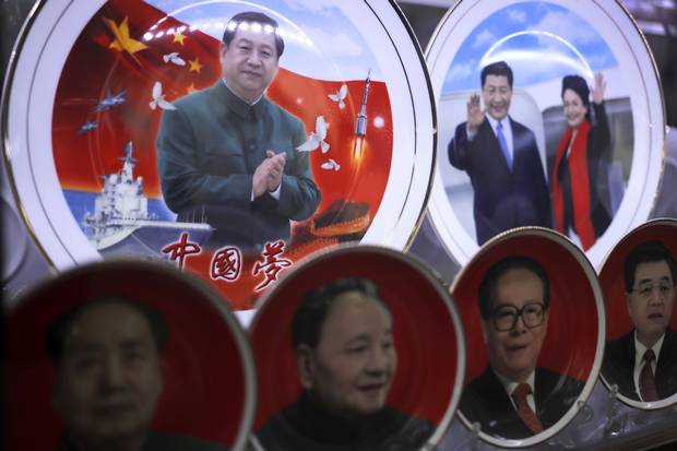 Porcelain plates with images of Chinese President Xi Jinping and his wife, Peng Liyuan, are displayed at a souvenir shop near Tiananmen Square. Below are previous Chinese leaders Mao Zedong, Deng Xiaoping, Jiang Zemin and Hu Jintao.