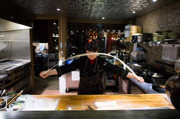 Chef Sonia Yuan pulls noodles for the hand-pulled spicy noodle dish.