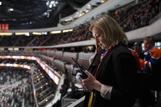 Rogers Place vice president and general manager Susan Darrington keeps in contact with her team while inspecting the arena before an Edmonton Oilers pre-season game in Edmonton, Alta., on Tuesday, Oct. 4, 2016.