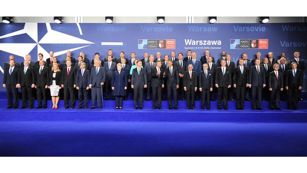 Leaders and ministers of NATO member states pose for a group photo at the PGE National Stadium in Warsaw on July 8, 2016.