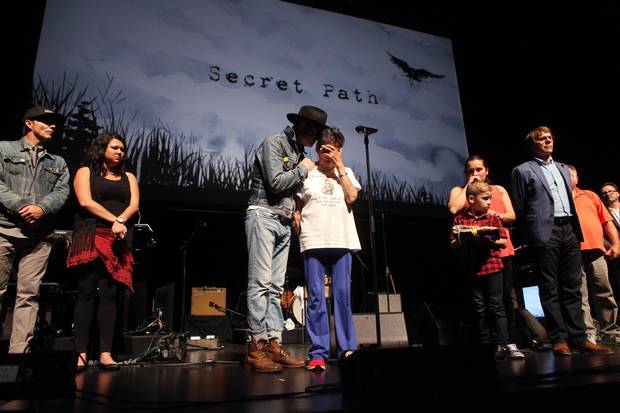 Gord Downie comforts Pearl Wenjack after she performed a traditional Anishinaabe healing song at the National Arts Centre.