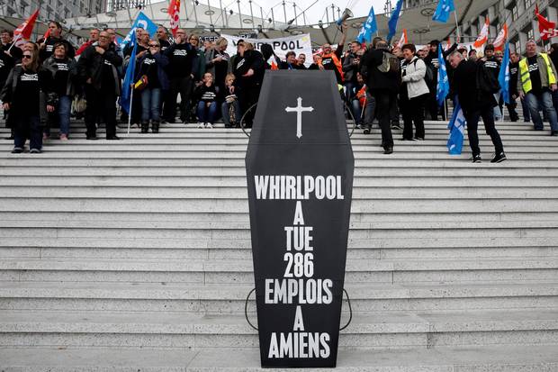 A makeshift coffin, reading ‘Whirlpool killed 286 jobs in Amiens,’ is seen as Whirlpool Amiens factory employees demonstrate outside the company headquarters at the financial and business district of La Defense, west of Paris, on April 18, 2017.