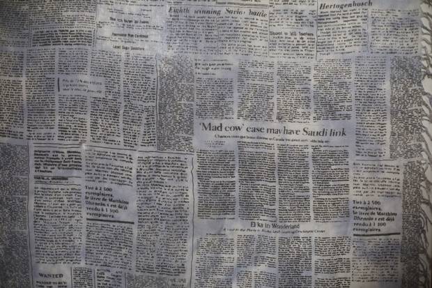 The scarf shows an article by Ms. Pruden about mad-cow disease from an April, 2011, edition of the Edmonton Journal.