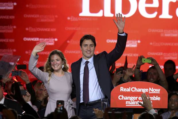 Justin Trudeau waves while accompanied by his wife, Sophie Grégoire Trudeau, after giving his victory speech after Canada's federal election on Oct. 19, 2015.