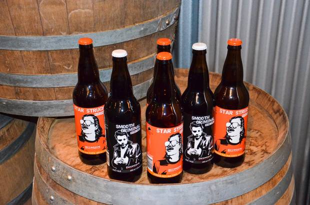 Deep Cove Brewers and Distillers’s modern tasting lounge is. surrounded by Douglas firs and stacked with barrels.