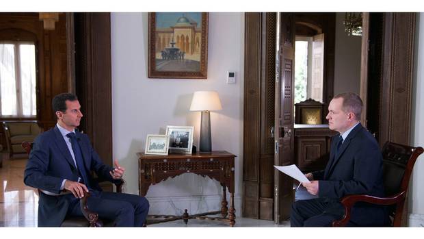 Syrian President Bashar Assad, left, speaks to Ian Phillips, vice-president of international news for Associated Press.