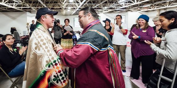 Traditional knowledge keeper Paul Carl, right, participates in a blanket ceremony in Kingston with with Geoff Green, leader of the Canada C3 expedition.