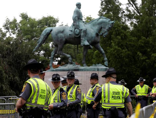 Virginia State Troopers stand under a statue of Robert E. Lee before a white supremacist rally in Charlottesville, on Aug. 12, 2017.