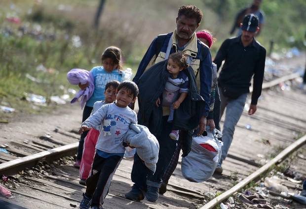 Migrants cross the border between Hungary and Serbia near Roszke village on Sept. 14, 2015.