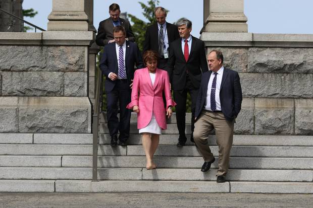 Premier Christy Clark and Green Party Leader Andrew Weaver, leave the legislature to speak to media during an April 2016 press conference. The pair developed a working relationship in the legislature, for instance when Ms. Clark adopted Mr. Weaver's proposal to require universities to create sexual assault policies.