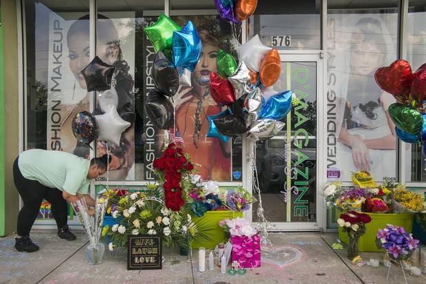 A makeshift memorial set up for Luis Conde and Juan Rivera Velazquez outside the salon they owned, D’Magazine.