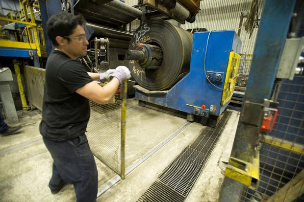 Steel rolls are prepared to be cut.