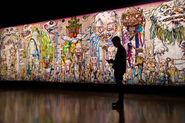 A man is silhouetted against Mr. Maurkami's artwork at Vancouver Art Gallery. Mr. Murakami is on a 'boom' as he calls it, with multiple museum shows, wild demand and critical success.