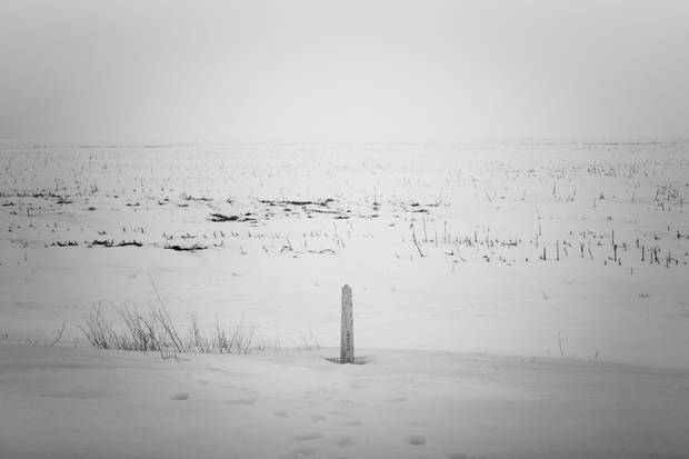 A marker shows the Canada-U.S. border in Emerson, Man.