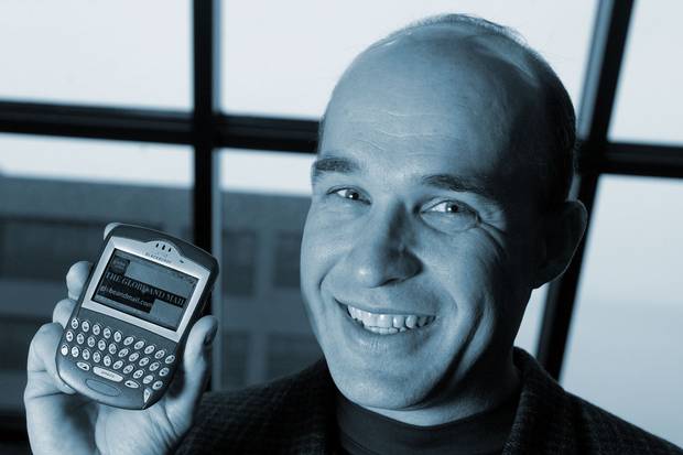 Nov. 5, 2003: Jim Balsillie, co-CEO of Research in Motion, holds a Blackberry 7230 showing The Globe and Mail’s website. The BlackBerry was a pioneering Canadian achivement in mobile-phone technology, but it became known to its fans and detractors alike as the ‘CrackBerry’ for how addictive it could be to use.