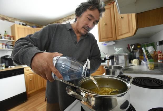 Blain Commanda of the Serpent River First Nation uses bottled water while cooking soup on Dec 20 2016. The Serpent River First Nation, located west of Sudbury, Ont., is still under a Do Not Drink water advisory even though the community has a new water treatment plant.