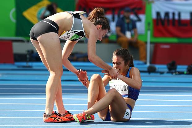 Abbey D'Agostino of the United States (R) is assisted by Nikki Hamblin of New Zealand after a collision during the Women's 5,000-metre Round 1 - Heat 2 on Day 11 of the Rio 2016 Olympic Games at the Olympic Stadium on August 16, 2016 in Rio de Janeiro, Brazil.