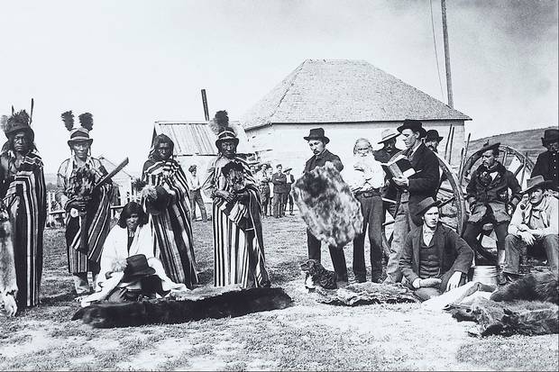 Fort Pitt, NWT, 1884: Plains Cree chief Big Bear and his sons trade with European settlers.