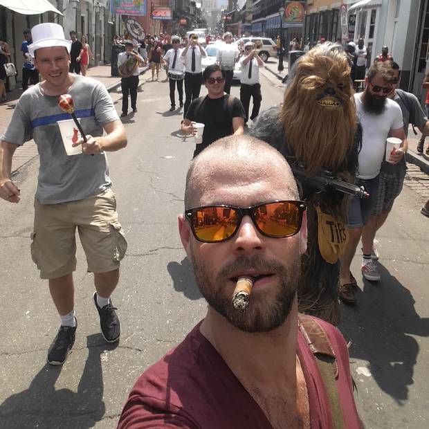 Chris, the groom in a top hat, leads the parade with his trusty sidekick, Chewbacca.