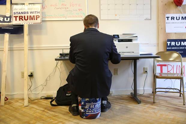 Blake West calls voters asking them to vote for Republican presidential canddiate Donald Trump while working at the Trump campaign headquarters on Feb. 8 2016 in Newmarket, New Hampshire.