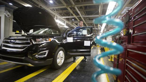 Employees with Ford Edges on the line following Ford's official kick-off of the new 2015 Ford Edge production at the assembly plant in Oakville, Ontario on Thursday, February 26, 2015.