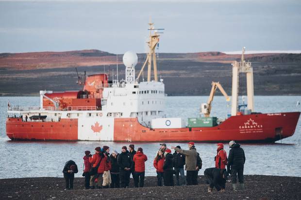 Canada C3 participants explore a rocky beach where members of the Canadian Arctic Expedition camped more than a century ago.