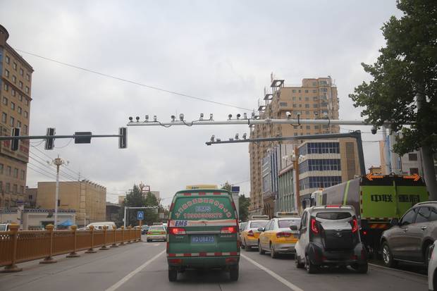 Surveillance cameras hang above the streets in Xinjiang. The government closely monitors where Xinjiang residents travel, how often they pray, what they wear and how they use the Internet.