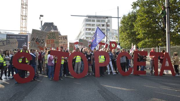 Protesters hold an anti-CETA banner during a demonstration against international trade agreements in Brussels on Sept. 20, 2016.