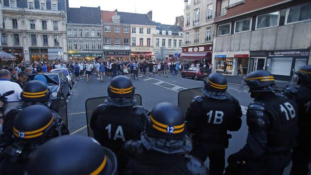 England supporters gestures towards a line of police officers in downtown Lille, France Wednesday, June 15, 2016 one day ahead of the Euro 2016 soccer match against Wales in nearby Lens. 